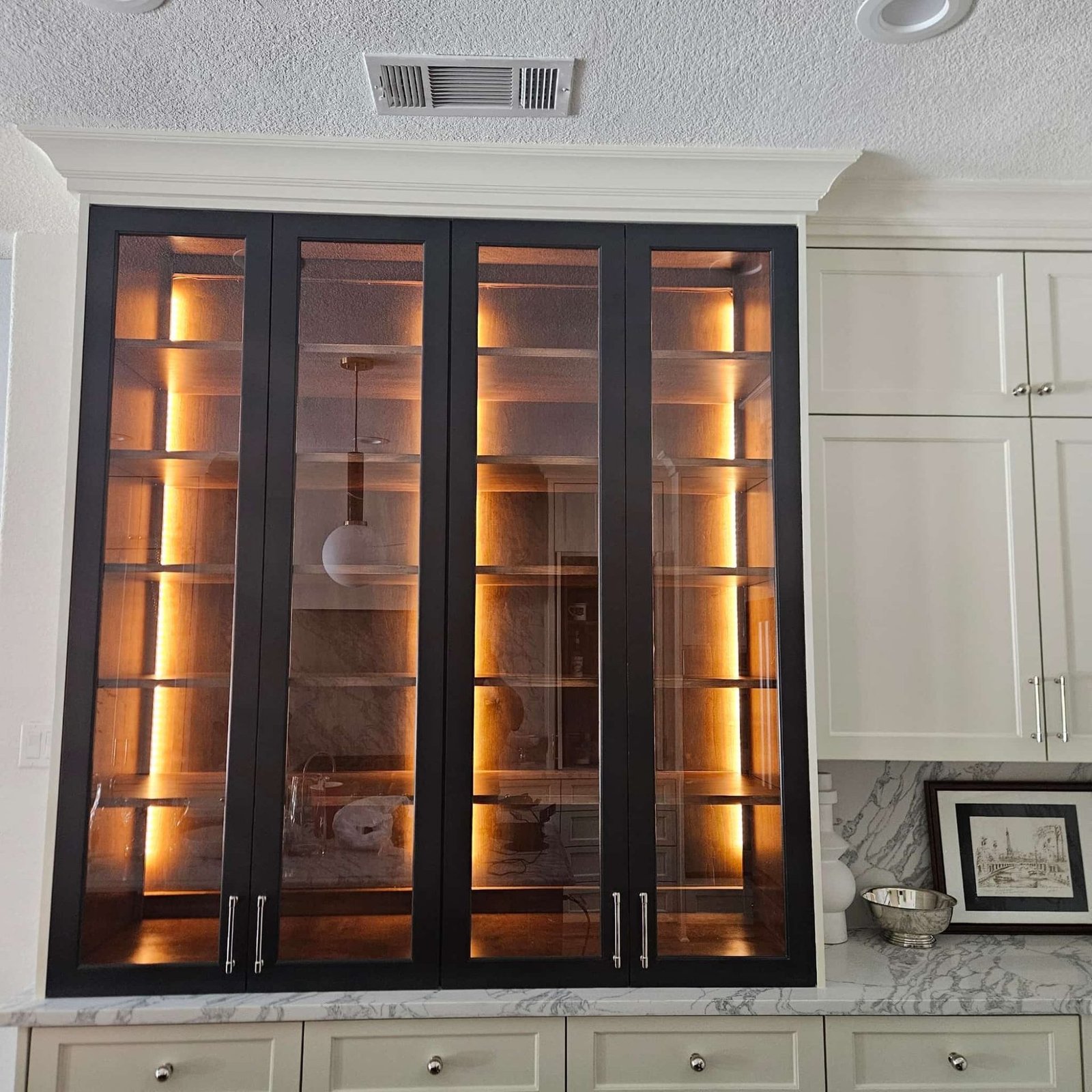 Black glass-front display cabinets