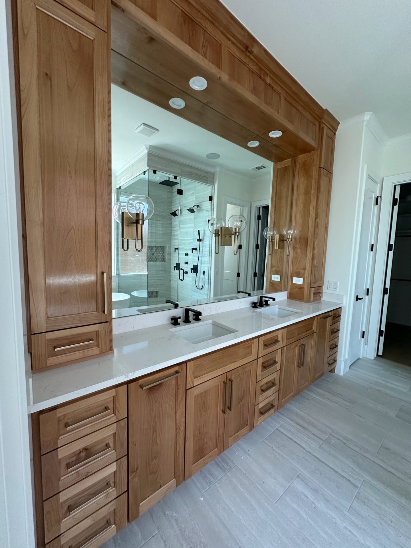 Custom wood bathroom vanity with dual sinks and brass hardware