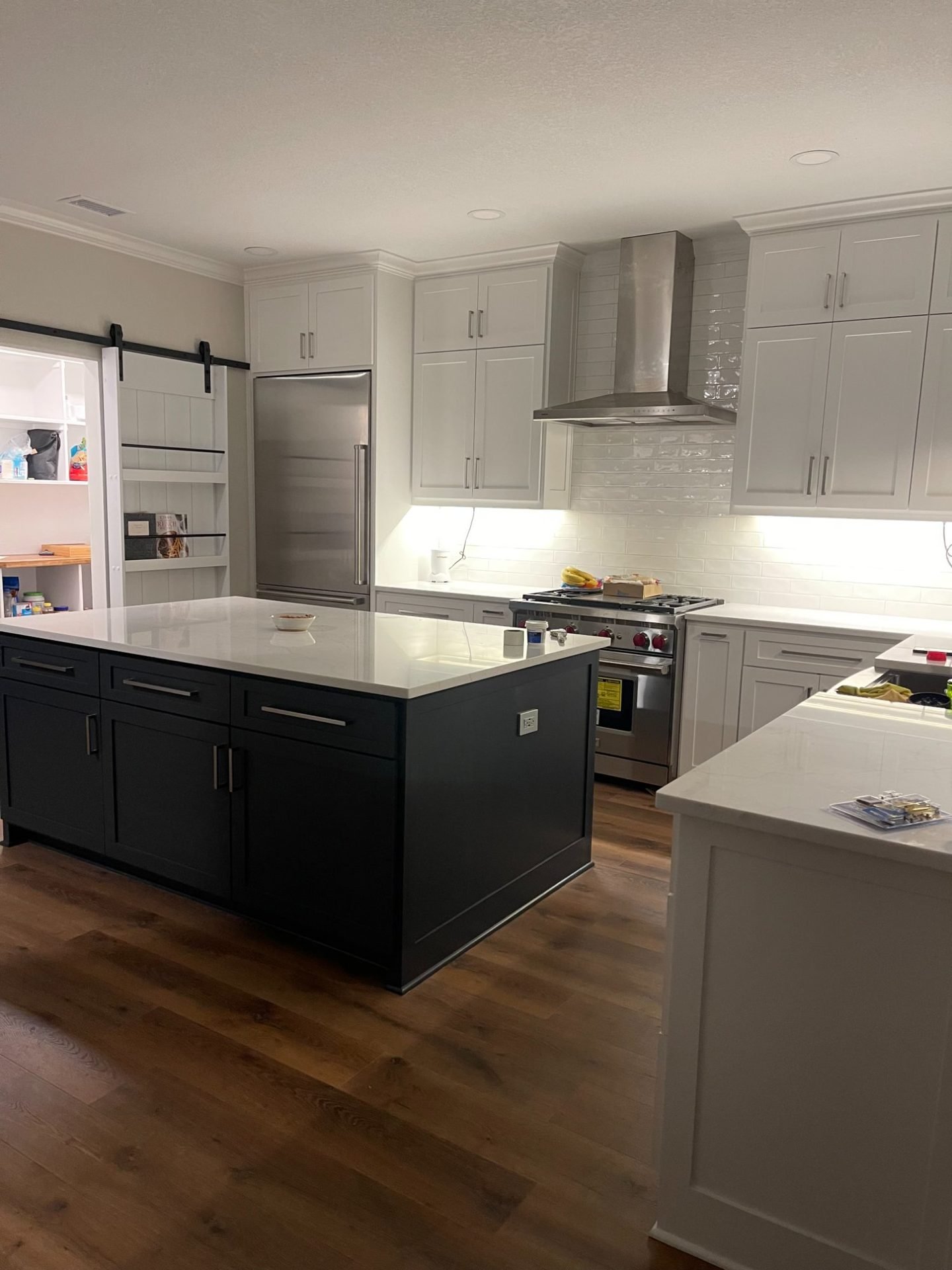 White and dark contrast kitchen with barn door